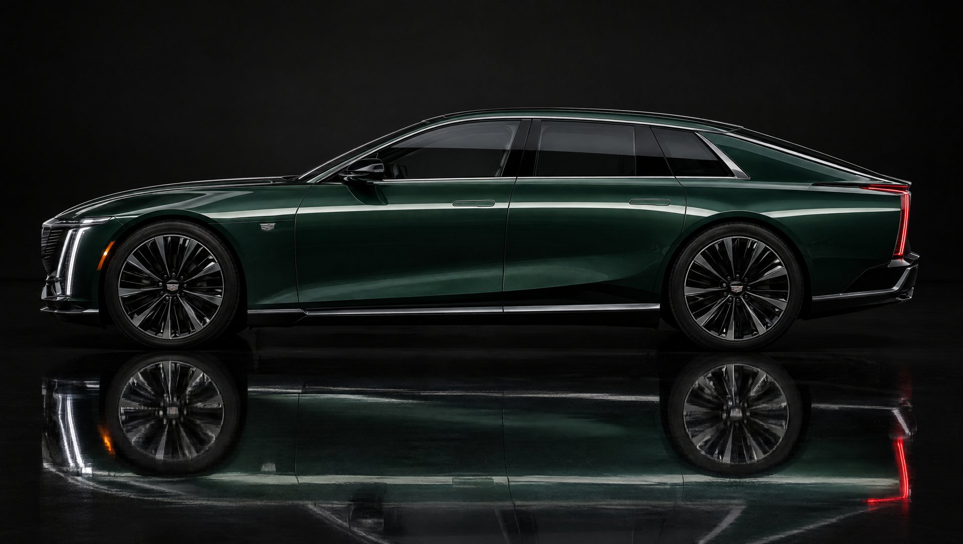 Dark green sedan in a black studio