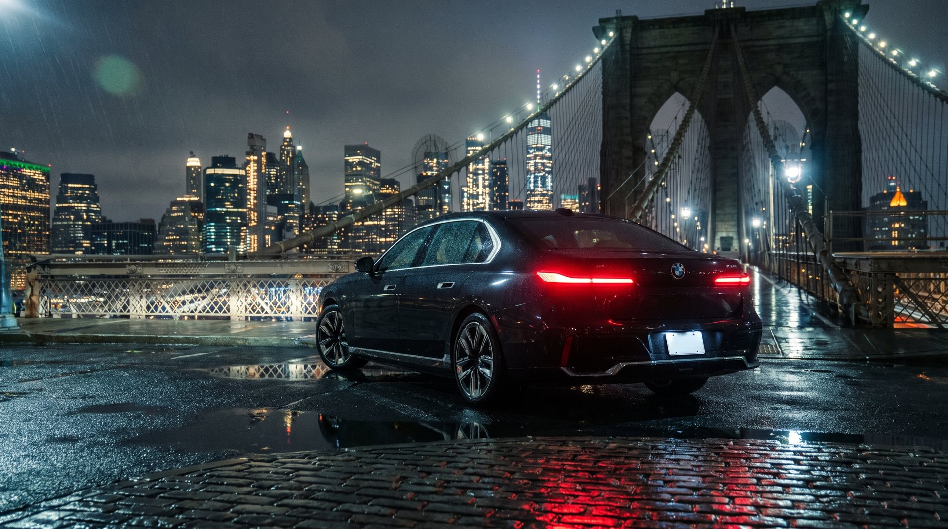 Sedan under a suspension bridge at night
